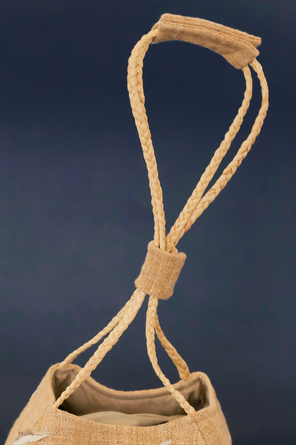 Sunset Boulevard bag made from natural and repurposed materials and featuring a one-of-a-kind hand ornamental applique on the bag's body. Wear it on your shoulders or hold it in your hands with the adjustable strap for a charming nighttime look.