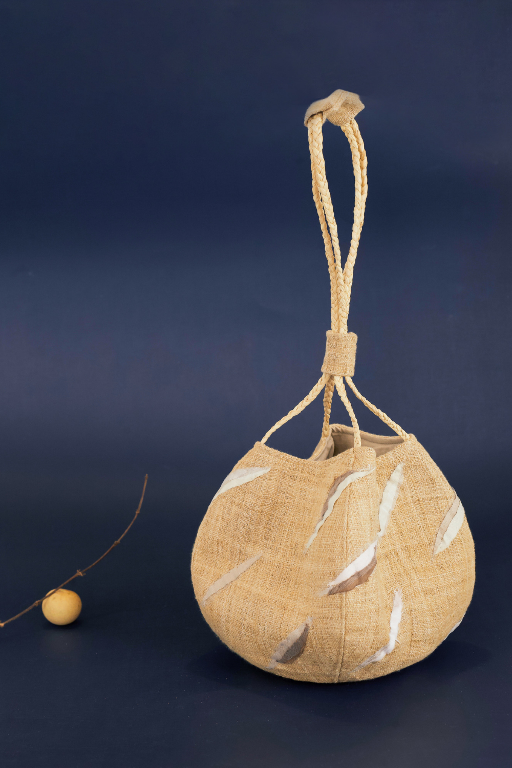 Sunset Boulevard bag made from natural and repurposed materials and featuring a one-of-a-kind hand ornamental applique on the bag's body. Wear it on your shoulders or hold it in your hands with the adjustable strap for a charming nighttime look.