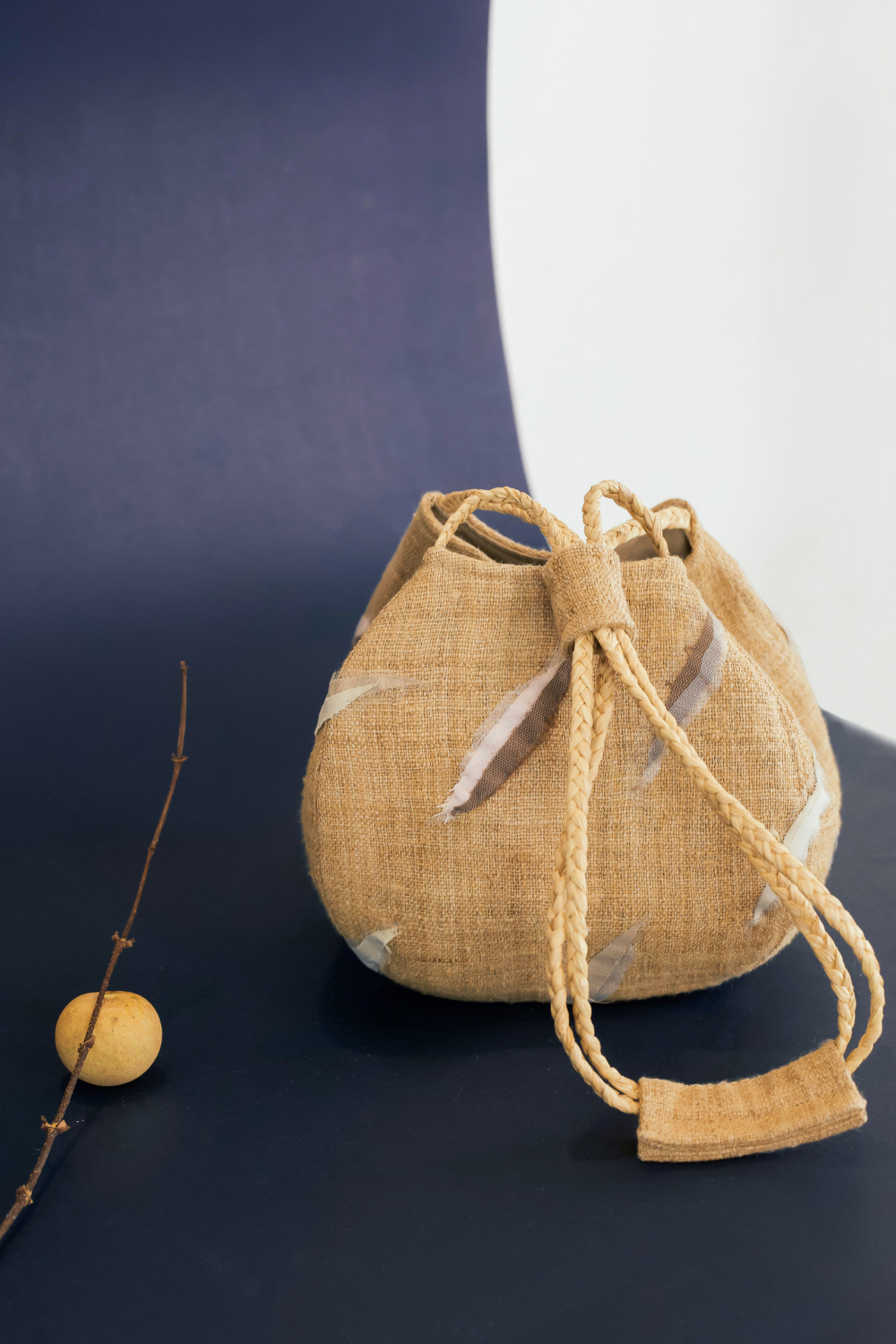 Sunset Boulevard bag made from natural and repurposed materials and featuring a one-of-a-kind hand ornamental applique on the bag's body. Wear it on your shoulders or hold it in your hands with the adjustable strap for a charming nighttime look.