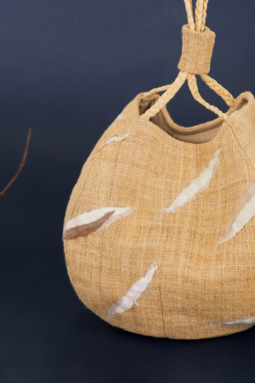 Sunset Boulevard bag made from natural and repurposed materials and featuring a one-of-a-kind hand ornamental applique on the bag's body. Wear it on your shoulders or hold it in your hands with the adjustable strap for a charming nighttime look.