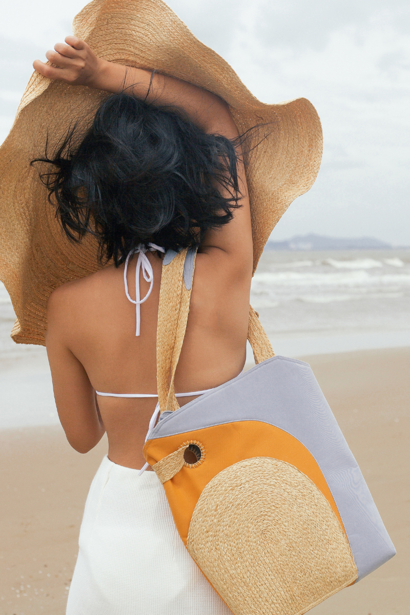 The Life on Mars bag, shaped quite like a tote bag, is handcrafted from natural Raffia, surrounded by layers of premium cotton and delicately contoured. There is a "secret pocket" inside the raffia piece on the front.