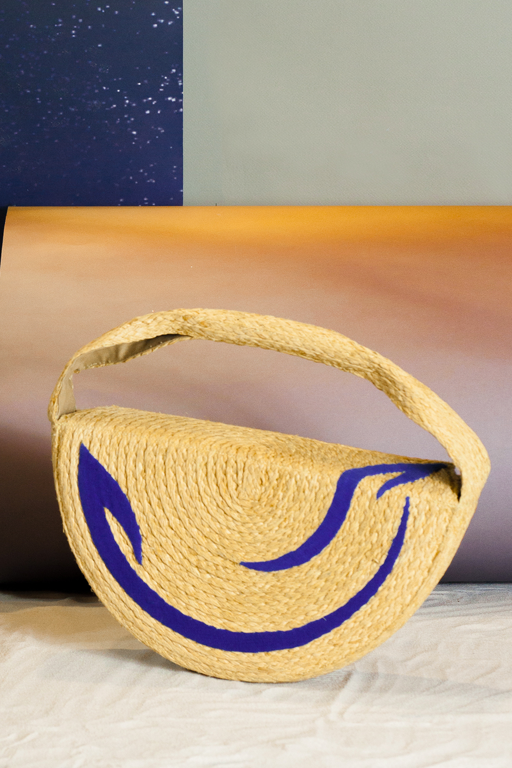 The shape of the cosmica bag is half a circle. The two sides of the bag feature a moving image of the universe made of épuré fabric