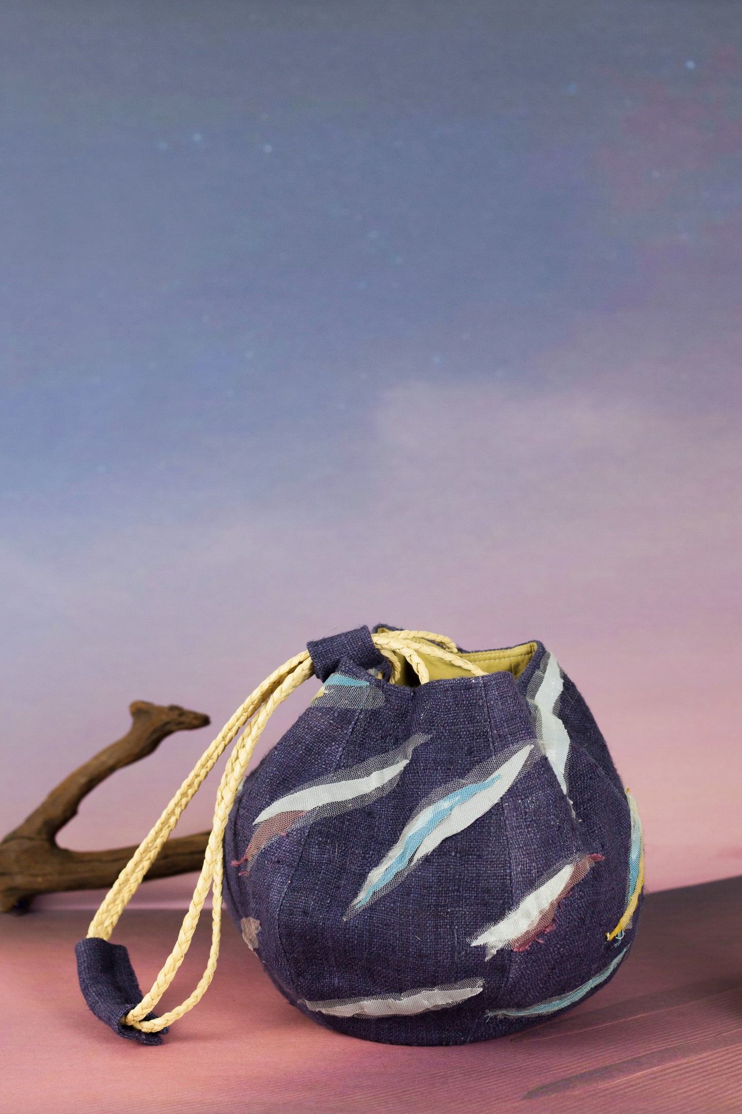 Sunset Boulevard bag made from natural and repurposed materials and featuring a one-of-a-kind hand ornamental applique on the bag's body. Wear it on your shoulders or hold it in your hands with the adjustable strap for a charming nighttime look.