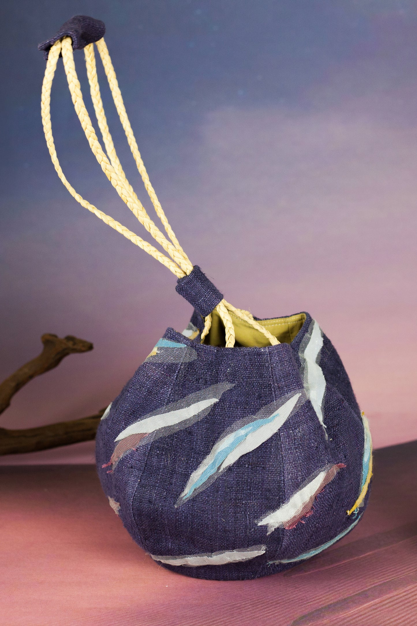 Sunset Boulevard bag made from natural and repurposed materials and featuring a one-of-a-kind hand ornamental applique on the bag's body. Wear it on your shoulders or hold it in your hands with the adjustable strap for a charming nighttime look.