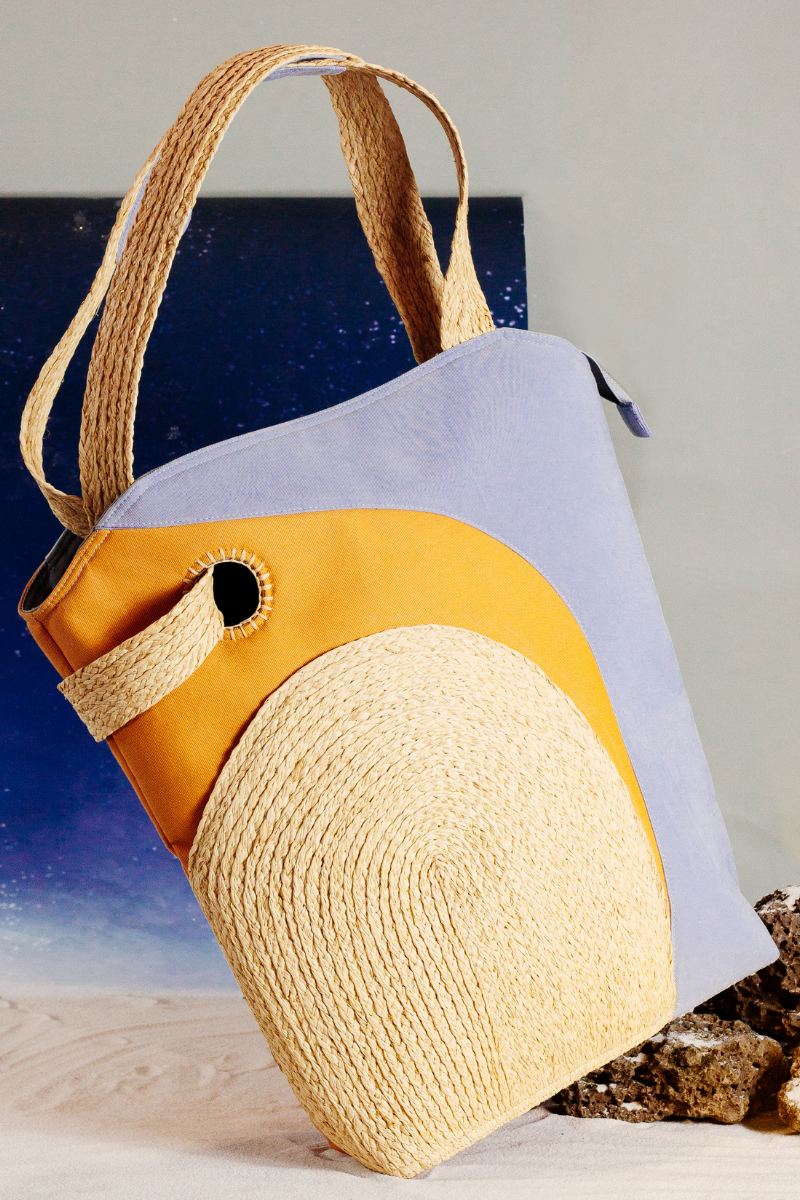 The Life on Mars bag, shaped quite like a tote bag, is handcrafted from natural Raffia, surrounded by layers of premium cotton and delicately contoured. There is a "secret pocket" inside the raffia piece on the front.