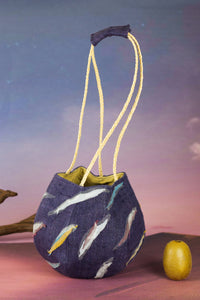 Sunset Boulevard bag made from natural and repurposed materials and featuring a one-of-a-kind hand ornamental applique on the bag's body. Wear it on your shoulders or hold it in your hands with the adjustable strap for a charming nighttime look.